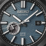 Seiko Astron SSJ039J1 solar GPS watch with stainless steel band and black dial, showing time and world time display.